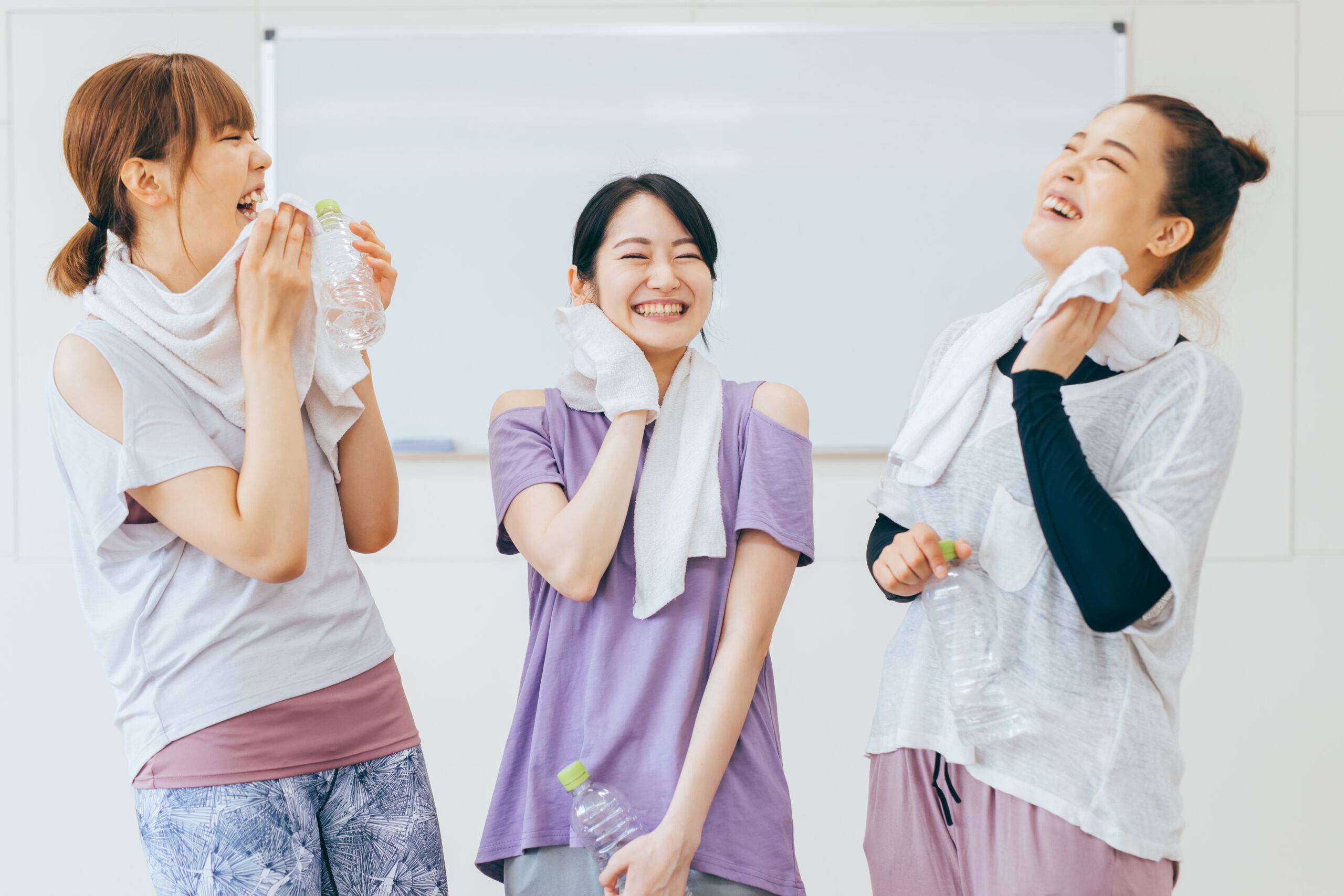 Group of people smiling and relaxing after a workout | Exxceed Wellness