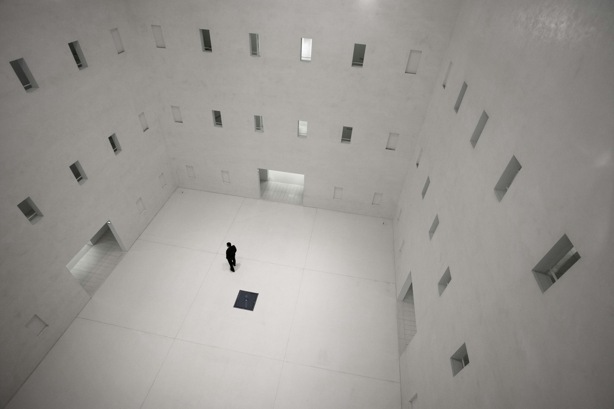 Lone figure in a vast minimalist atrium — options after SSRIs for anxiety, Exxceed Wellness, Hayward CA